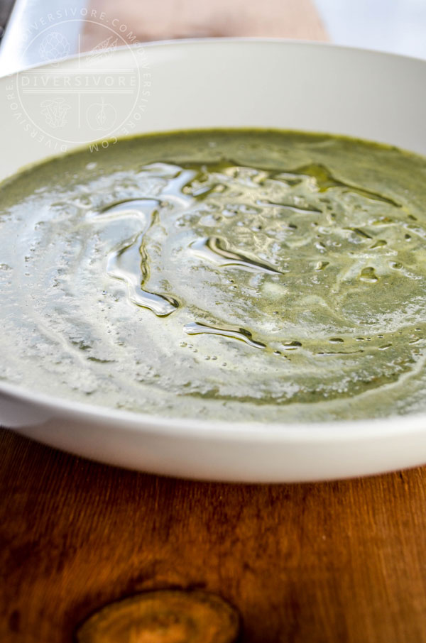 Nettle Cream Soup in a large white bowl on a wooden backdrop