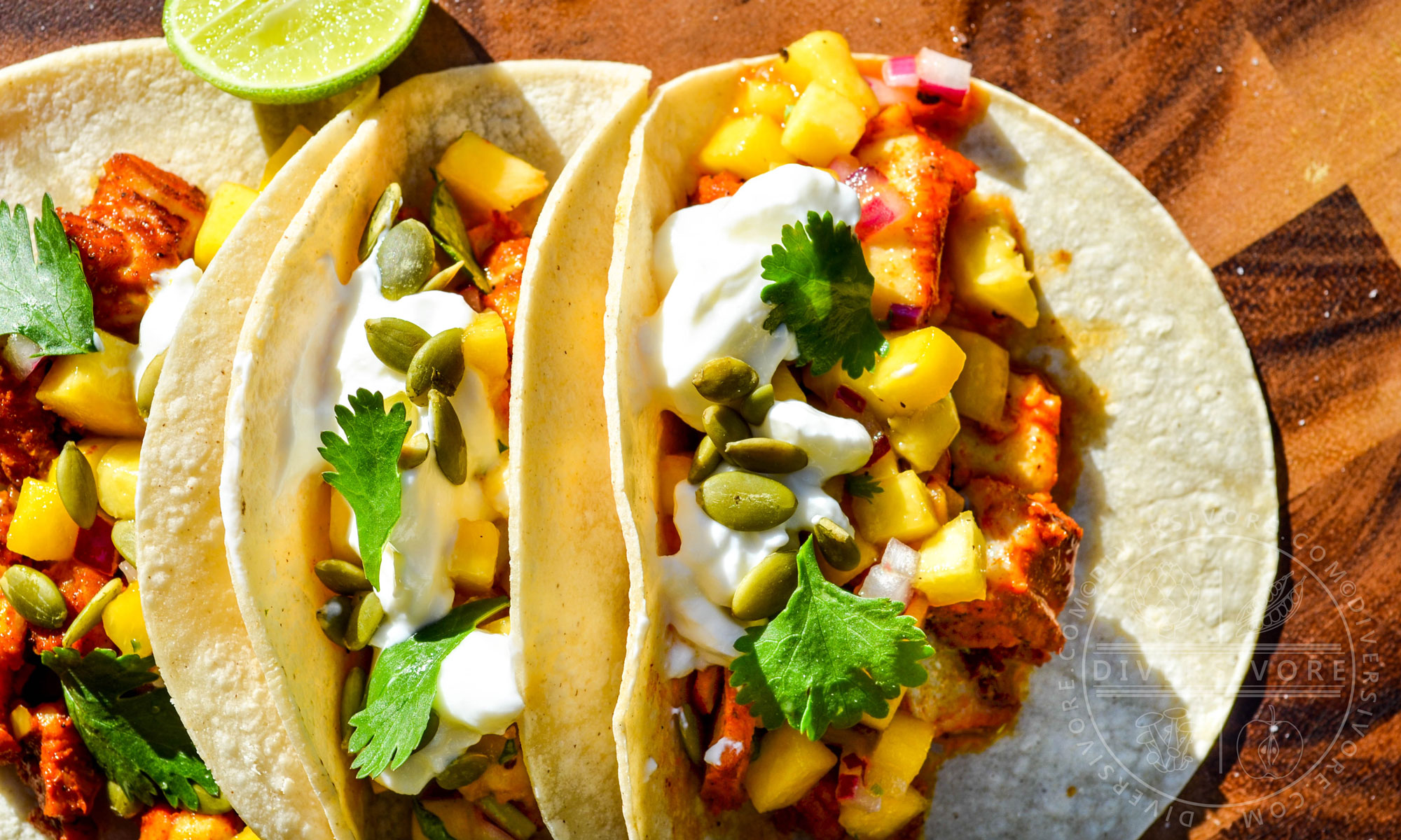 Yucatecan Fish Tacos with peach salsa, sour cream, and pumpkin seeds