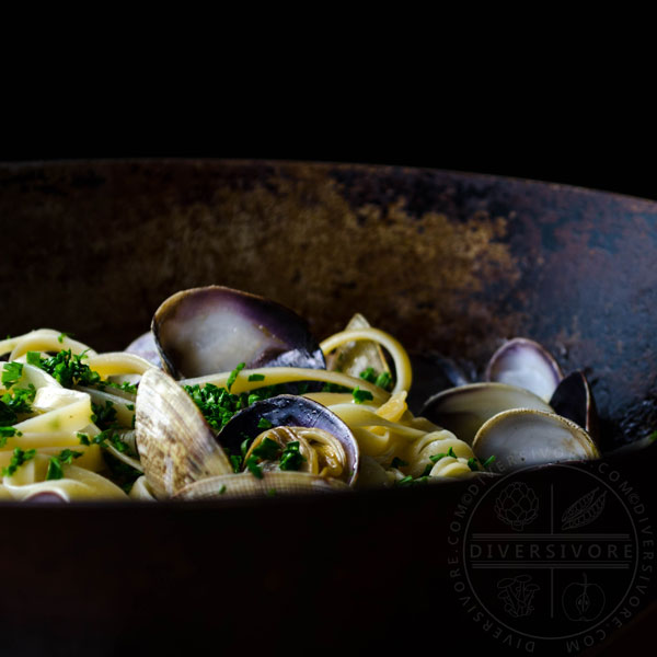 Pasta alle vongole (with white wine, olive oil, and clams) in a large wok