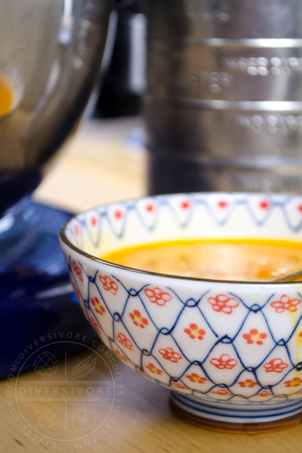 Whipped eggs in a patterned red, white, and blue bowl