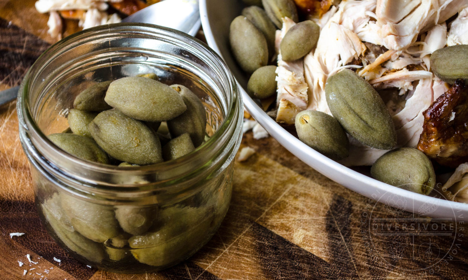 Pickled fresh green almonds, served here with roasted chicken - Diversivore.com