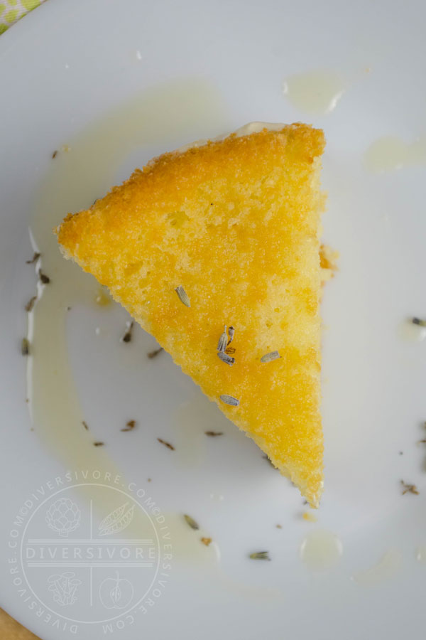 A slice of Lemon, Lavender, and Honey Semifreddo Cake on a white plate, shown from overhead